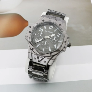 Close-up of gunmetal quartz watch dial with three subdials and steel link bracelet