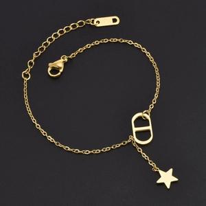 Golden stainless steel chain bracelet with CD initials and star charms on black background