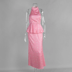 Detail of pink floral satin maxi set showing halter neck and peplum bubble hem design