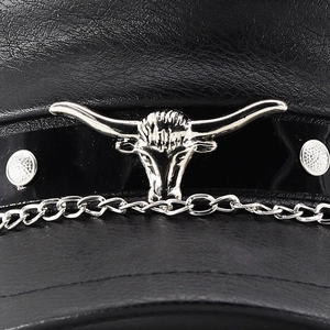 Detail of black PU leather hat featuring silver bull head charm and metal chain accents