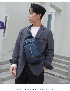 Detail of blue waterproof nylon crossbody bag featuring multi-pocket storage and buckle strap