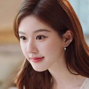 Silver crawler earrings with cubic zirconia star pendants worn on female model