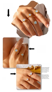 Detail showing set of four gold-plated opal rings with heart and floral motifs