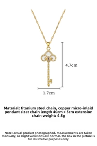 Detailed view of luxury key pendant necklace with crystals and white enamel inlay