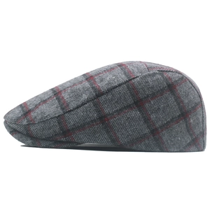 Side view of gray plaid newsboy cap with red and black vintage wool patterns