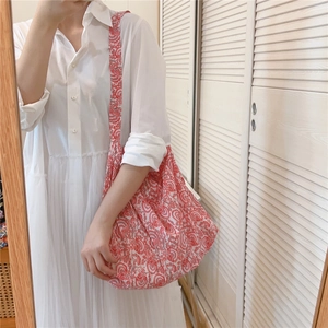 Floral print cotton tote bag with wide shoulder strap shown in a casual mirror selfie