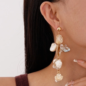 Bohemian ocean style long drop earrings with white shell pieces and gold shell pendant