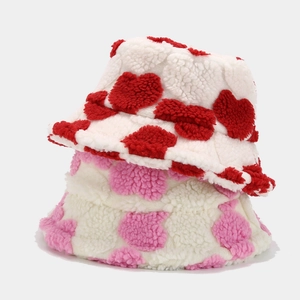 Winter plush bucket hat with heart pattern in red and pink fleece material
