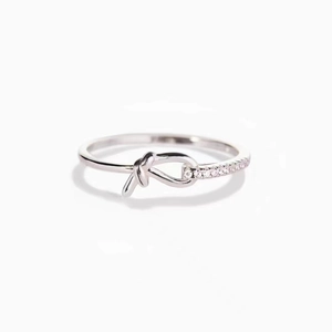 Polished silver knotted ring with pavé-set sparkling crystals in a minimalist design