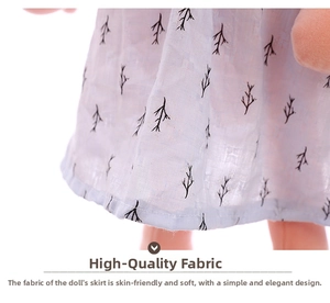 Detail of light blue doll dress with black branch patterns and delicate stitching