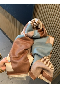 Close-up of color-block scarf with brown blue stripes and elegant fringe details