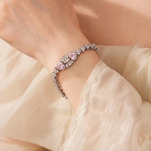 Silver bracelet detail with pink heart zircon and white marquise stones on wrist