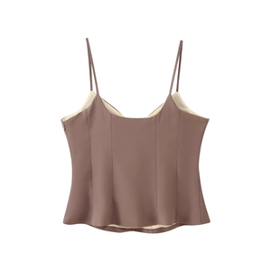 Detail of a brown camisole top featuring thin straps and a peplum waist design