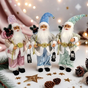 Detailed trio of pastel Santa figurines with lanterns and sequined hats for Xmas decor