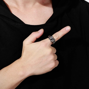 Close-up of vintage silver double fist ring in titanium steel on male model's finger