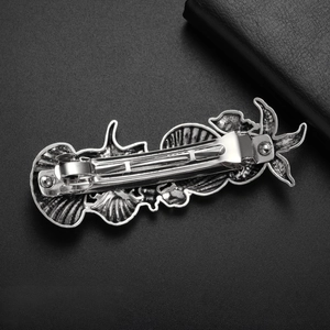 Detail of vintage silver starfish and shell hair clip with spring-loaded metal back