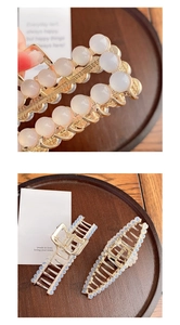 Detail of elegant gold metal hair claws with translucent resin pearls on wood background