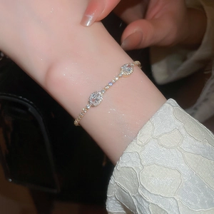 Detail of adjustable gold bracelet with double oval zircons and micro-pave diamond halo