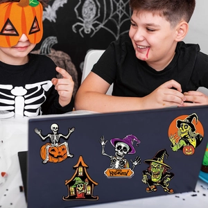 Detail of Halloween gnome and skull magnetic stickers on a laptop during a festive party
