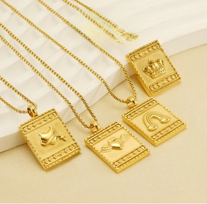 Close-up of gold plated stainless steel square tag necklaces with embossed relief patterns