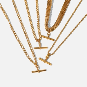 Detail view of gold stainless steel necklace collection with T-bar toggles and mixed chains