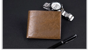 Detailed view of a brown textured leather wallet with professional stitching and business props