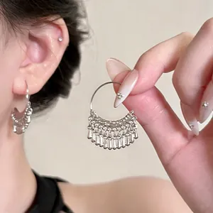 Close-up of vintage flower beaded fringe earrings featuring elegant silver tassels