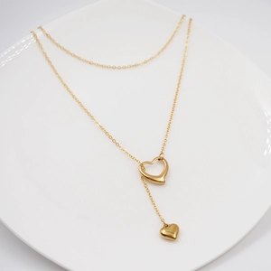 Double layered gold titanium necklace featuring hollow heart pendant and Y-shaped chain