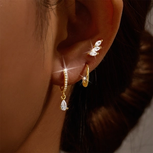 Detail of 3-piece gold S925 silver earring set with marquise and teardrop crystals