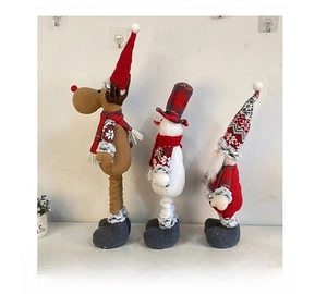 Side view of three-piece Christmas plush figurines including reindeer snowman and gnome