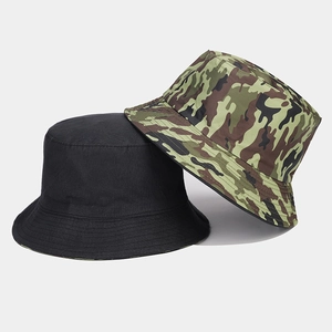 Detail of reversible bucket hat in black and jungle camouflage with reinforced stitching