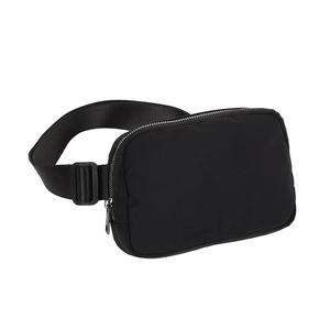 Close-up of black nylon waist bag showing durable shoulder strap connection and metal zipper