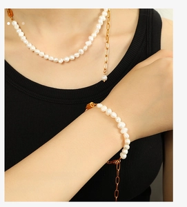 Detail shot of fashion pearl and gold chain necklace and bracelet jewelry set