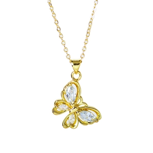 Macro detail of golden butterfly pendant with sparkling marquise and pear-shaped crystals