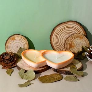 Detail of double heart-shaped candle holder with natural wooden slice decoration