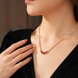 Elegant gold tennis necklace with sparkling white zircons and five red round gemstones
