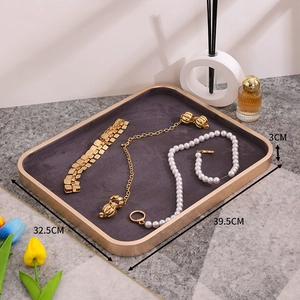 Elegant beige velvet jewelry display tray with gold metal frame for rings and necklaces