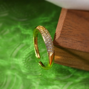 Macro view of gold-plated adjustable ring with micro-pave cubic zirconia inlay