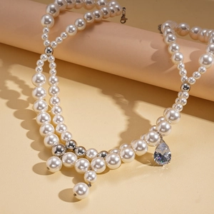 Detail of elegant double-layer pearl necklace with teardrop cubic zirconia pendant
