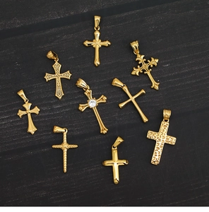 Macro view of nine different 18K gold plated titanium cross pendants with crystals
