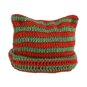 Detail of red and green striped knit hat featuring cute crochet devil cat ears design