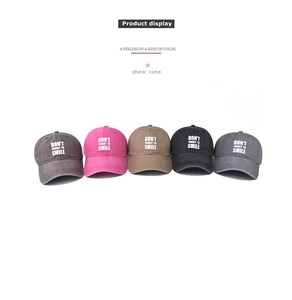 Five washed cotton baseball caps with 'DON'T FORGET TO SMILE' text in various colors