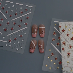 Detail of 3D star nail art stickers with metallic gold and silver patterns for manicure