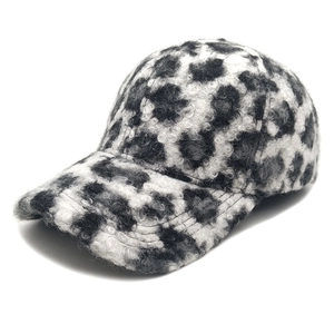 Close-up of leopard print baseball cap featuring warm fuzzy sherpa fleece texture