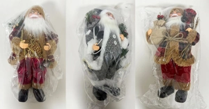 Detailed view of three standing Santa Claus figurines in different festive plaid outfits