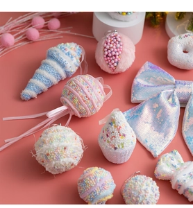 Detail of pink candy-themed Christmas ornaments featuring foam macaron balls and cupcake shapes