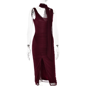 Detail view of burgundy mesh dress with draped neckline, ruched design and front slit