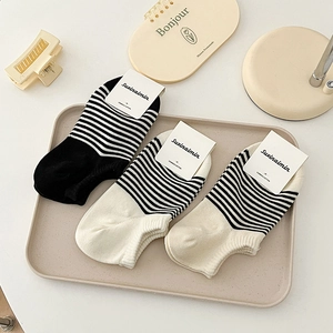 Three pairs of striped combed cotton low-cut boat socks for women on a tray