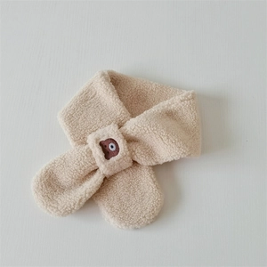 Detail of beige fleece scarf for kids featuring cute bear embroidery and cross-fix closure