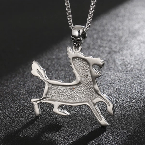 Close-up of silver steel pendant featuring a mythical creature and small skull detail